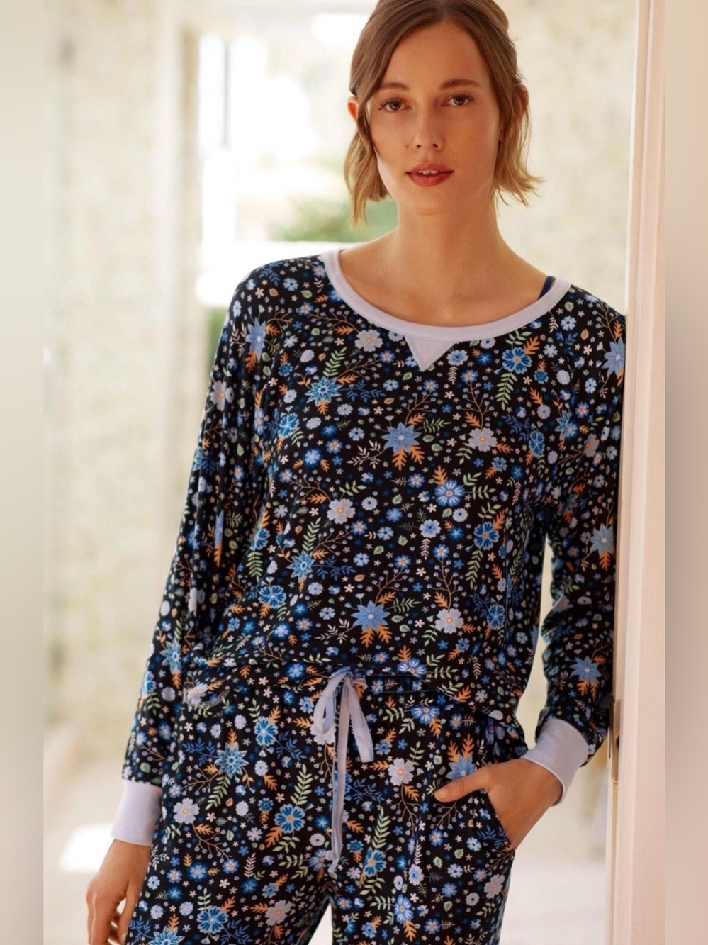 Flora Nikrooz Black Floral Long-Sleeve Lounge Top and matching jogger pants.